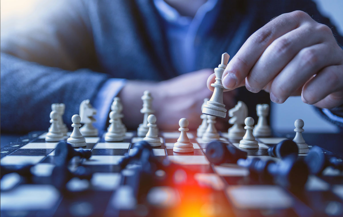 a man moving chess pieces on a board