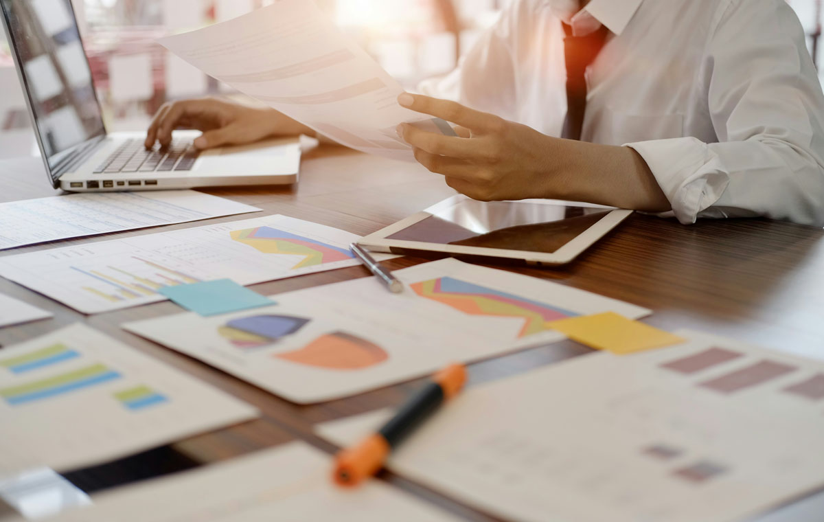 A woman works at a desk with papers and an iPad on brand positioning